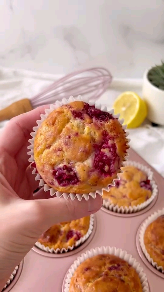 a hand holding a muffin