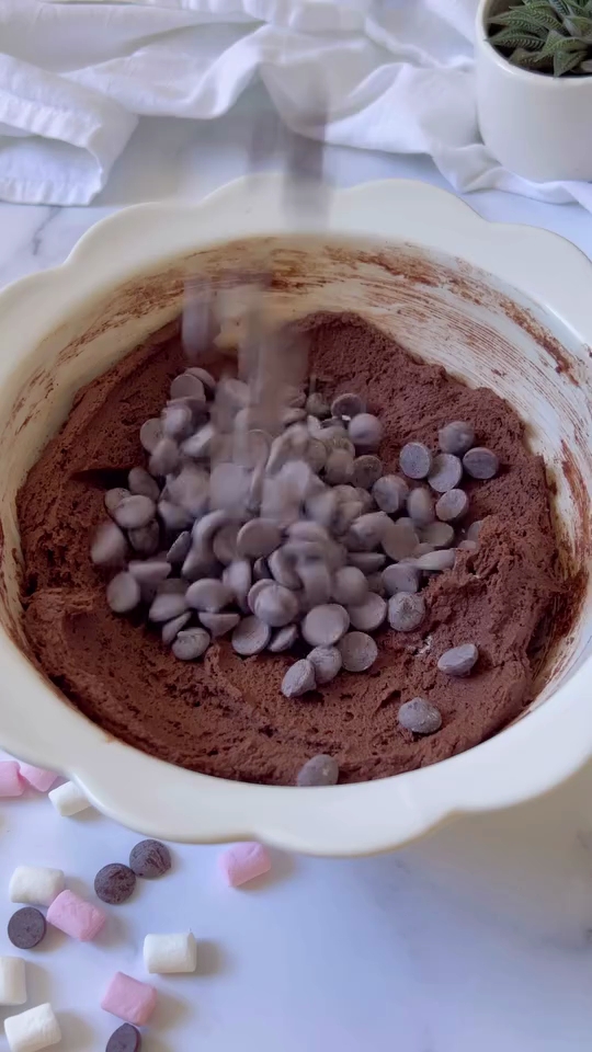 a bowl of chocolate chips being poured into a bowl