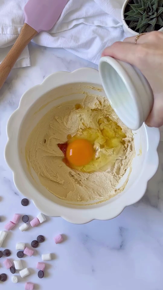 a bowl of dough with a egg yolk and a white lid